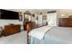 Well-lit carpeted primary bedroom with a tray ceiling, dresser, and a large window at 10554 Hyde Park, Carmel, IN 46032