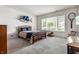 Spacious bedroom with a queen-sized bed and a large window with backyard view at 10554 Hyde Park, Carmel, IN 46032