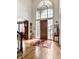 Grand foyer with high ceilings, hardwood floors, and a large arched window over front door at 10554 Hyde Park, Carmel, IN 46032