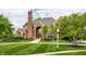 Charming front exterior of brick home with lush landscaping and neatly trimmed lawn at 10554 Hyde Park, Carmel, IN 46032