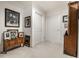 Hallway adorned with framed photos, complemented by a wooden cabinet and neutral walls, creating a gallery-like feel at 10554 Hyde Park, Carmel, IN 46032