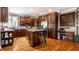 Modern kitchen featuring wood cabinets, granite countertops, and stainless steel appliances at 10554 Hyde Park, Carmel, IN 46032