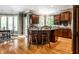 Well-lit kitchen featuring a central island, modern appliances, and hardwood floors at 10554 Hyde Park, Carmel, IN 46032