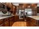 Well-equipped kitchen with stainless steel appliances, wood cabinets, and granite countertops at 10554 Hyde Park, Carmel, IN 46032