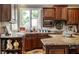 Well-maintained kitchen with modern appliances, wood cabinets, and stone countertops at 10554 Hyde Park, Carmel, IN 46032