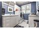 Bright laundry room with white cabinetry, sink, and modern appliances at 10554 Hyde Park, Carmel, IN 46032