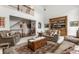 Bright living room with hardwood floors, comfortable seating, and a large window at 10554 Hyde Park, Carmel, IN 46032