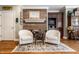 Cozy living room with hardwood floors, comfortable seating, and a fireplace at 10554 Hyde Park, Carmel, IN 46032