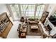 Open living room with high ceilings, large windows, and comfortable seating at 10554 Hyde Park, Carmel, IN 46032