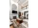 Elegant living room featuring a fireplace, statement mirror, and comfortable seating at 10554 Hyde Park, Carmel, IN 46032