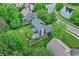 Stunning aerial view of a landscaped yard, stone patio, raised garden beds, and well-maintained home in a desirable neighborhood at 10906 Camden Ct, Fishers, IN 46038