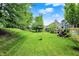 Well-manicured lawn and landscaping surrounds the home in this backyard shot at 10906 Camden Ct, Fishers, IN 46038