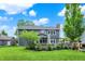 View of the home's backyard with lush green lawn, garden, and patio space at 10906 Camden Ct, Fishers, IN 46038