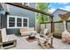 Backyard patio featuring a fire pit, wooden benches, and mature trees for shade at 10906 Camden Ct, Fishers, IN 46038