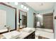 Bathroom featuring a double vanity with modern vessel sinks and a glass-enclosed shower/tub at 10906 Camden Ct, Fishers, IN 46038