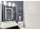 Stylish half bathroom featuring modern vanity, shiplap accent wall, and sleek fixtures at 10906 Camden Ct, Fishers, IN 46038