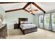 Spacious bedroom with vaulted ceiling, exposed beams, ceiling fan, and light paint at 10906 Camden Ct, Fishers, IN 46038