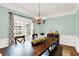 Cozy dining room featuring a large wooden table, stylish decor, and ample natural light at 10906 Camden Ct, Fishers, IN 46038