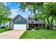 Charming two-story home featuring a covered front porch, a spacious lawn, and an attached two-car garage at 10906 Camden Ct, Fishers, IN 46038
