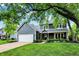 Charming two-story home with a well-manicured lawn, a covered front porch, and a convenient two-car garage at 10906 Camden Ct, Fishers, IN 46038