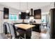 Bright kitchen with black cabinets, a butcher block island, stainless steel appliances, and eat-in dining area at 10906 Camden Ct, Fishers, IN 46038