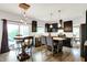 Modern kitchen featuring dark cabinets, pendant lighting, and an inviting eat-in area at 10906 Camden Ct, Fishers, IN 46038