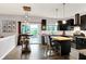 Modern kitchen features black cabinetry, butcher block island, stainless appliances, and deck access at 10906 Camden Ct, Fishers, IN 46038