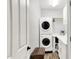 Functional laundry room featuring stacked washer and dryer, custom cabinets, and ample storage space at 10906 Camden Ct, Fishers, IN 46038