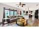 Cozy living room featuring a large sectional couch, modern decor, and seamless flow to the kitchen at 10906 Camden Ct, Fishers, IN 46038