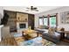 Relaxing living room featuring a brick fireplace, wood accent wall, comfortable seating, and stylish decor at 10906 Camden Ct, Fishers, IN 46038