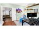 Home office features a desk, floating shelves, a plush chair, and an inviting open doorway at 10906 Camden Ct, Fishers, IN 46038