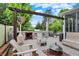Backyard patio with stone fireplace, built-in grill, wood benches, and comfortable seating near firepit at 10906 Camden Ct, Fishers, IN 46038