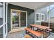 Cozy screened-in patio featuring a wooden picnic table and view to the backyard area at 10906 Camden Ct, Fishers, IN 46038
