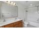 Bathroom featuring a double vanity, large mirror, bathtub/shower combo, and an adjacent toilet for added functionality at 1111 Cavendish Dr, Carmel, IN 46032