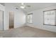 Bright bedroom with vaulted ceiling, ceiling fan, and two windows at 1111 Cavendish Dr, Carmel, IN 46032