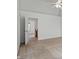 Neutral carpeted bedroom with a ceiling fan and access to a bright hallway leading to other rooms in the home at 1111 Cavendish Dr, Carmel, IN 46032