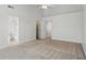 Bedroom with neutral carpeting, ceiling fan, and multiple doors for easy access to bathroom and closet spaces at 1111 Cavendish Dr, Carmel, IN 46032