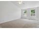 Spacious bedroom with neutral carpeting, a ceiling fan, and large windows providing abundant natural light at 1111 Cavendish Dr, Carmel, IN 46032