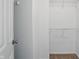 Organized walk-in closet with neutral carpeting and multiple shelves and rods for storing clothes and other personal items at 1111 Cavendish Dr, Carmel, IN 46032