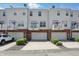 Townhome with brick and white siding, garages, and small balconies at 1111 Cavendish Dr, Carmel, IN 46032