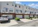 View of townhome row featuring private garage and upper balconies at 1111 Cavendish Dr, Carmel, IN 46032