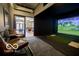 Golf simulator room with comfortable leather chairs and a virtual display at 1111 Cavendish Dr, Carmel, IN 46032