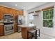 Well-appointed kitchen with stainless steel appliances, kitchen island, and breakfast bar at 1111 Cavendish Dr, Carmel, IN 46032