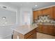 Bright kitchen featuring a kitchen island, stainless steel appliances, and wooden cabinets at 1111 Cavendish Dr, Carmel, IN 46032