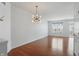 Inviting living room with hardwood floors and a modern light fixture at 1111 Cavendish Dr, Carmel, IN 46032
