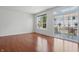 Light-filled living room with hardwood floors, large windows, and access to outdoor space at 1111 Cavendish Dr, Carmel, IN 46032