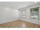 Neutral room showcases tile flooring, two windows with blinds, and recessed lighting at 1111 Cavendish Dr, Carmel, IN 46032