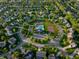 Aerial view of a community with a clubhouse, pool, tennis courts, basketball courts, and beautiful green spaces at 11727 Wedgeport Ln, Fishers, IN 46037