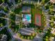 Aerial view of community recreational amenities including basketball courts, tennis courts, a pool and a clubhouse at 11727 Wedgeport Ln, Fishers, IN 46037