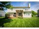 Spacious backyard with a wooden deck, pergola, and lush green lawn at 11727 Wedgeport Ln, Fishers, IN 46037